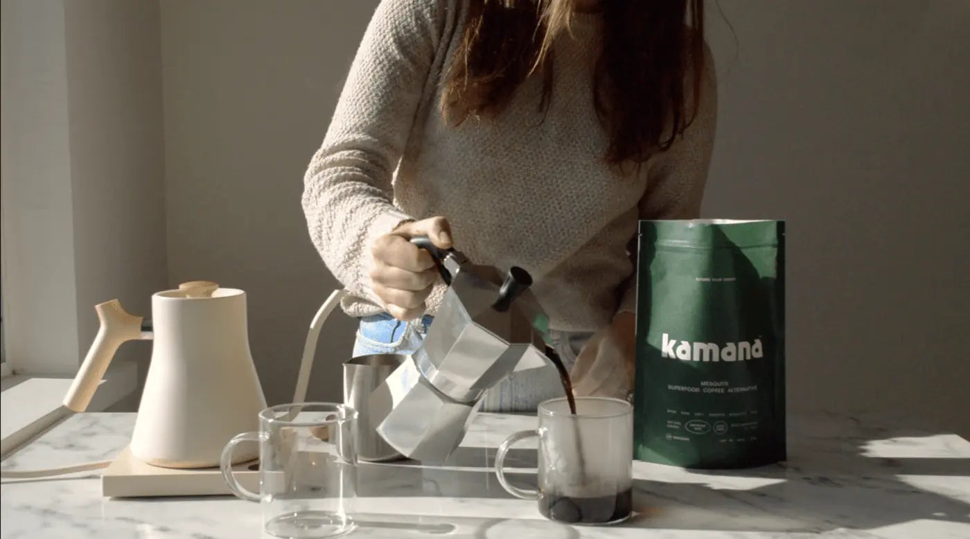 Woman pouring freshly brewed Kamana mesquite coffee, a natural energy-boosting coffee replacement, from a moka pot into a glass mug
